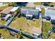 An aerial view of a fenced backyard with a patio, fire pit, and green space at 2406 25Th W Ave, Bradenton, FL 34205