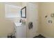 This bathroom features tiled floors and walls, a black framed mirror, and modern fixtures at 2406 25Th W Ave, Bradenton, FL 34205