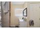 This bathroom features tiled floors and walls, a black framed mirror, and modern fixtures at 2406 25Th W Ave, Bradenton, FL 34205