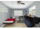 This bedroom features pale blue walls, light wood floors, and a bright window at 2406 25Th W Ave, Bradenton, FL 34205