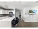 Modern kitchen featuring white cabinets, a breakfast bar, and sleek countertops at 2406 25Th W Ave, Bradenton, FL 34205