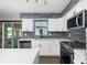 Stylish kitchen with white cabinets, stainless steel appliances, and stone backsplash at 2406 25Th W Ave, Bradenton, FL 34205