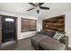 Cozy living room with hardwood floors, a sectional sofa, and unique accent wall at 2406 25Th W Ave, Bradenton, FL 34205