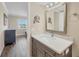Bathroom with a large mirror, decorative vanity, faucet, and fixtures, plus a view to the bedroom at 250 Santa Maria St # 215, Venice, FL 34285