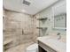 Bathroom featuring decorative tile, a glass enclosed shower, and updated vanity at 250 Santa Maria St # 215, Venice, FL 34285