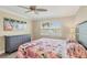 Bright bedroom with flamingo art, ceiling fan, and scenic marina view at 250 Santa Maria St # 215, Venice, FL 34285