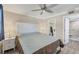 Bedroom with a ceiling fan, walk-in closet with laundry and an en-suite bathroom at 250 Santa Maria St # 215, Venice, FL 34285