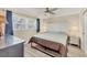 Bedroom with a ceiling fan, accent lamps, natural light, and neutral color palette at 250 Santa Maria St # 215, Venice, FL 34285