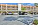 Exterior view of building 250 and covered parking spaces showcasing well-maintained architecture and parking convenience at 250 Santa Maria St # 215, Venice, FL 34285
