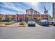 Clubhouse entrance with a well-maintained parking lot and landscaping at 250 Santa Maria St # 215, Venice, FL 34285