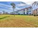 Beautiful condo community with a wide open green space and mature palm trees at 250 Santa Maria St # 215, Venice, FL 34285