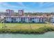 Beautiful waterfront condo building with lush green lawn and manicured landscaping at 250 Santa Maria St # 215, Venice, FL 34285