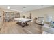 Bright game room featuring a pool table, bookshelf, and comfortable seating at 250 Santa Maria St # 215, Venice, FL 34285