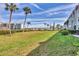 Beautifully landscaped community green-space with mature palm trees and views of the Intercoastal waterway at 250 Santa Maria St # 215, Venice, FL 34285