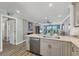 Open kitchen with stainless dishwasher and countertop overlooking living space at 250 Santa Maria St # 215, Venice, FL 34285