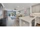 View of kitchen with stainless dishwasher and living and dining area at 250 Santa Maria St # 215, Venice, FL 34285
