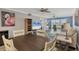 Open floor plan with dining area and living room with expansive windows at 250 Santa Maria St # 215, Venice, FL 34285