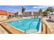 Large community pool with clear blue water and plenty of lounge chairs at 250 Santa Maria St # 215, Venice, FL 34285