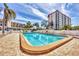 Relaxing community pool area with lounge chairs and lush landscaping at 250 Santa Maria St # 215, Venice, FL 34285