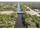 An aerial view of a long canal running through a lush, green landscape with bridges for roads at 2721 Burri Ter, North Port, FL 34288