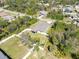 This aerial view features a home with mature landscaping, a fenced yard, and a driveway leading to the street at 2721 Burri Ter, North Port, FL 34288