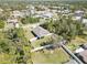 This aerial perspective shows a private backyard, encircled by mature trees, and full perimeter fencing at 2721 Burri Ter, North Port, FL 34288