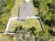 The aerial shot captures a manicured lawn, complemented by a full fence for security and privacy for outdoor living at 2721 Burri Ter, North Port, FL 34288