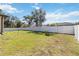 An expansive backyard with well-maintained green grass, fully enclosed by a white fence at 2721 Burri Ter, North Port, FL 34288