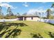 The spacious backyard features lush green grass and a screened-in patio, perfect for outdoor enjoyment at 2721 Burri Ter, North Port, FL 34288