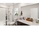 Well-lit bathroom with a glass-enclosed shower, white vanity, and a large mirror at 2721 Burri Ter, North Port, FL 34288