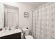 Cozy bathroom with modern fixtures, a vanity, and a shower with a decorative curtain at 2721 Burri Ter, North Port, FL 34288