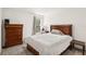 This bedroom features a plush bed, hardwood furniture, and a large window at 2721 Burri Ter, North Port, FL 34288