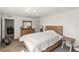 Bright bedroom with natural wood bed and view into the living room at 2721 Burri Ter, North Port, FL 34288