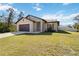 Inviting single-Gathering home with a two-car garage, green lawn, and a welcoming entrance at 2721 Burri Ter, North Port, FL 34288