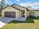 Charming single-story home with a spacious driveway, lush lawn, and well-maintained landscaping at 2721 Burri Ter, North Port, FL 34288