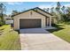 Charming single-story home with a spacious driveway, lush lawn, and well-maintained landscaping at 2721 Burri Ter, North Port, FL 34288
