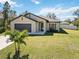 Charming single-story home with a spacious driveway, lush lawn, and well-maintained landscaping at 2721 Burri Ter, North Port, FL 34288