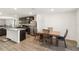 Open kitchen and dining area featuring stainless steel appliances and granite countertops at 2721 Burri Ter, North Port, FL 34288