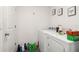 A simple laundry room with a white washer and dryer, plus shelves for storage at 2721 Burri Ter, North Port, FL 34288