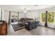 Bright living room featuring leather furniture, hardwood-style floors, and access to the outdoor patio at 2721 Burri Ter, North Port, FL 34288