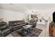 Spacious living room with hardwood floors, a leather sofa set, and an open-concept design at 2721 Burri Ter, North Port, FL 34288