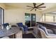 Outdoor patio features comfortable seating, a ceiling fan, and views of the surroundings at 2721 Burri Ter, North Port, FL 34288