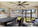 This outdoor patio includes comfortable seating, a ceiling fan, and a relaxing hot tub at 2721 Burri Ter, North Port, FL 34288