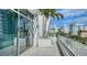 Outdoor balcony with potted palm trees and a glass railing offering city views at 280 Golden Gate Pt # 400, Sarasota, FL 34236