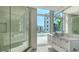 Bathroom showcasing a modern glass shower and vanity with an outside view at 280 Golden Gate Pt # 400, Sarasota, FL 34236