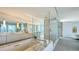 Luxurious bathroom featuring a marble bathtub and a glass shower at 280 Golden Gate Pt # 400, Sarasota, FL 34236
