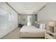 Well-lit bedroom featuring a large window, ceiling fan, and simple decor at 280 Golden Gate Pt # 400, Sarasota, FL 34236