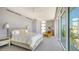 Bright bedroom with large window featuring a bed, lounge chair, and ceiling fan at 280 Golden Gate Pt # 400, Sarasota, FL 34236