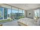 Bright bedroom with a large window, white bedding, and modern gray decor with views of the surrounding construction at 280 Golden Gate Pt # 400, Sarasota, FL 34236