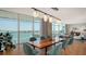 Bright dining room features hardwood floors, view of the water, and modern light fixtures at 280 Golden Gate Pt # 400, Sarasota, FL 34236